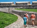 Tourists visiting a Spanish-colonial style fortified structure i