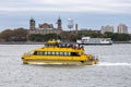 New York, New York - October 11, 2019 : A water taxi crosses in front of Ellis Island Royalty Free Stock Photo