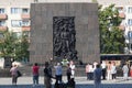 Tourists visiting and taking pictures in the Monument to the Ghetto Heroes in Warsaw, Poland