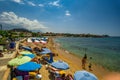 Tourists and visitors enjoy the summer at the sandy beach of Stoupa near Kardamili in Messinia, Greece