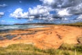 Tourists and visitors enjoying the sandy beach at Constantine Bay Cornwall England UK on the Cornish north coast in colourful HDR