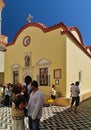 Tourists and visitors inside Panormitis monastery waiting at chapel entrance