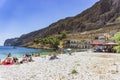 Tourists and visitors swimming by the old harbor at the coastal village of Gerolimenas. It is a small picturesque fishing village