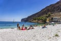 Tourists and visitors swimming by the old harbor at the coastal village of Gerolimenas. It is a small picturesque fishing village