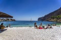 Tourists and visitors swimming by the old harbor at the coastal village of Gerolimenas. It is a small picturesque fishing village