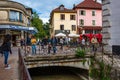 Tourists and visitors walking in the beautiful streets of Annecy town against a cloudy sky. Annecy, Haute Savoie, France Royalty Free Stock Photo