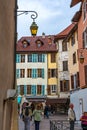 Tourists and visitors walking in the beautiful streets of Annecy town against a cloudy sky. Annecy, Haute Savoie, France Royalty Free Stock Photo