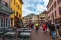 Tourists and visitors walking in the beautiful streets of Annecy town against a cloudy sky. Annecy, Haute Savoie, France Royalty Free Stock Photo