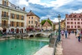 Tourists and visitors walking in the beautiful streets of Annecy town against a cloudy sky. Annecy, Haute Savoie, France Royalty Free Stock Photo