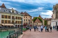 Tourists and visitors walking in the beautiful streets of Annecy town against a cloudy sky. Annecy, Haute Savoie, France Royalty Free Stock Photo