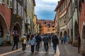 Tourists and visitors walking in the beautiful streets of Annecy town against a cloudy sky. Annecy, Haute Savoie, France Royalty Free Stock Photo