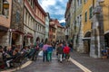 Tourists and visitors walking in the beautiful streets of Annecy town against a cloudy sky. Annecy, Haute Savoie, France Royalty Free Stock Photo