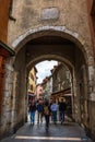 Tourists and visitors walking in the beautiful streets of Annecy town against a cloudy sky. Annecy, Haute Savoie, France Royalty Free Stock Photo