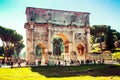 Tourists visits the famous Arch of Constantine in Rome, Italy