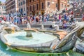 Tourists visits Piazza Spagna, detail of Fontana della Barcaccia