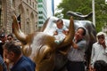 Tourists visits the Wall Street Charging Bull statue Royalty Free Stock Photo