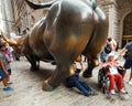 Tourists visits the Wall Street Charging Bull statue Royalty Free Stock Photo