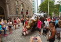 Tourists visits the Wall Street Charging Bull statue Royalty Free Stock Photo