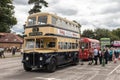 Tourists wait to board classic old buses for a bus ride at a classic and vintage vehicle event