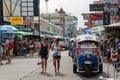 Tourists walk along backpacker haven Khao San Road and tuktuk in Bangkok,