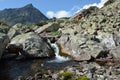 Tourists walk along a key in a mountain valley Barguzinsky ridge Royalty Free Stock Photo