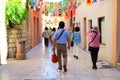 Tourists walk along the old town in Sibenik, Croatia. People go sightseeing in the historical center of the Croatian city