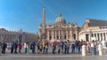 Tourists walk around and observe the beautiful architecture of Vatican City.