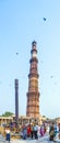 Tourists walk around Qutub Minar