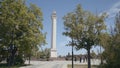 Tourists walk in city park with monument to warrior. Action. Beautiful lively Victory Park with monument and dancing