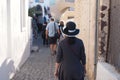 Tourists walk down narrow City walkway