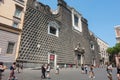 Tourists walk of the Immaculate Virgin on Piazza Gesu Nuovo in Naples, Italy