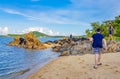 Tourists walk on Koh Samui island beach coast rocks Thailand Royalty Free Stock Photo