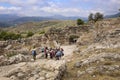 Tourists walk through the Lion`s Gate of Mycenae citadel Royalty Free Stock Photo