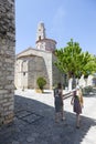 Tourists walk near ancient church of areopolis in greece on mani Royalty Free Stock Photo