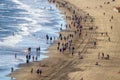 Tourists walk over the beach