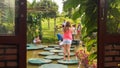 Tourists walk on planked footways for feeding fish in lake