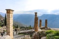 Tourists walk through the runis at ancient Delphi with valley and mountains in the background on foggy day Delphi Greece 1 8 2018