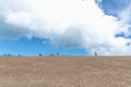 Tourists walk on the sand near the Rubjerg Knude Lighthouse on the coast of the North Sea in the Jutland in northern