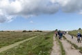 Tourists walk on the sand near the Rubjerg Knude Lighthouse on the coast of the North Sea in the Jutland in northern