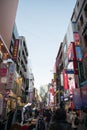 Tourist walk on street along high building in walkin street in