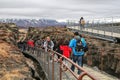 Tourists walk to Haukadalur Geyser Valley