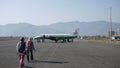 Tourists walk to a small inland plane,Yeti Airlines in Pokhara