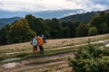 Tourists walk through the Ukrainian Carpathians, tourists carry heavy backpacks on their backs. Royalty Free Stock Photo