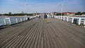 Tourists walking along Brzezno Pier, one of resort boroughs of Gdansk, Poland