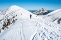 Tourists walking along the ridge of snowy mountains Royalty Free Stock Photo