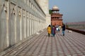 Tourists walking around the base of the Taj Mahal