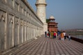 Tourists walking around the base of the Taj Mahal