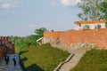 Tourists walking around old castle wall