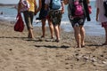 Tourists walking on beach