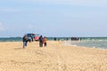 Tourists walking on the beach Royalty Free Stock Photo